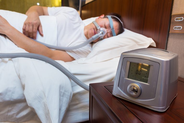 Cpap,Machine,Sitting,On,The,Bedside,Table,Next,To,The Cpap,Machine,Sitting,On,The,Bedside,Table,Next,To,The